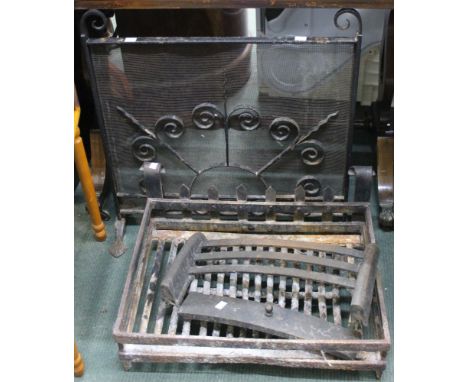 A wrought iron metal spark guard and a fire grate