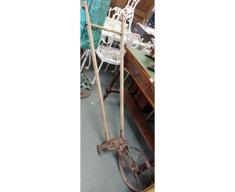 A vintage push weeding machine