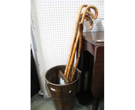 A wooden metal banded stick stand with contents