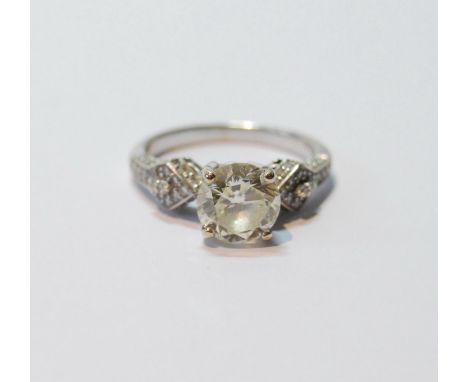 Diamond solitaire ring with brilliant and others, smaller, at the shoulders, 2.23ct, in 18ct gold, size P, with certificate a