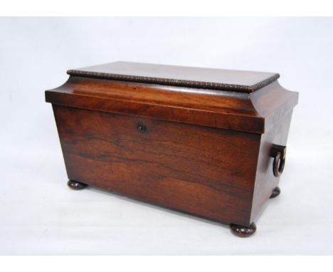 19th century rosewood sarcophagus tea caddy of large form enclosing twin compartments, lacking the mixing jar, with ring hand