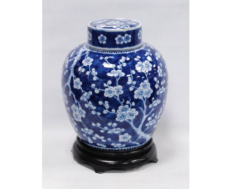 Chinese Kangxi-style oviform vase and cover with all over white prunus decoration on a blue ground, four character mark of Ka