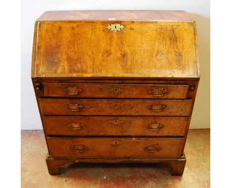 Mid-18th century walnut bureau, the fall front enclosing drawers and pigeon holes, above four graduated drawers flanked by pu