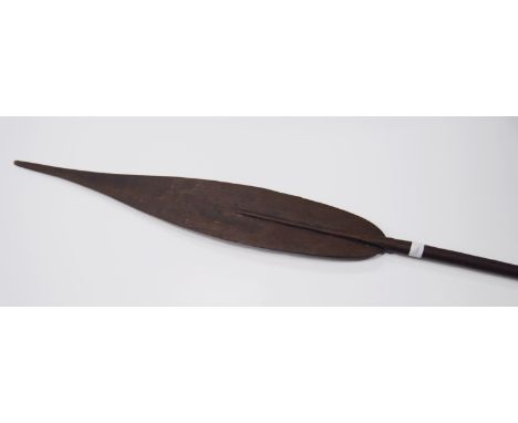 Indonesian carved wood paddle/spear, possibly from the Dayak Tribe, with incised markings to the harp-shaped grip, 171cm long