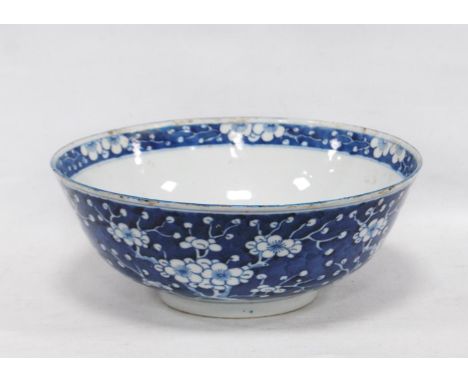 Chinese Kangxi-style bowl with all over white prunus decoration on a blue ground, four character mark of Kangxi within two co