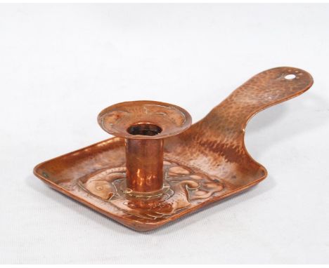 Arts &amp; Crafts Newlyn hammered copper chamber stick with repoussé fish decoration, stamped 'Newlyn', 4cm high and 22cm lon