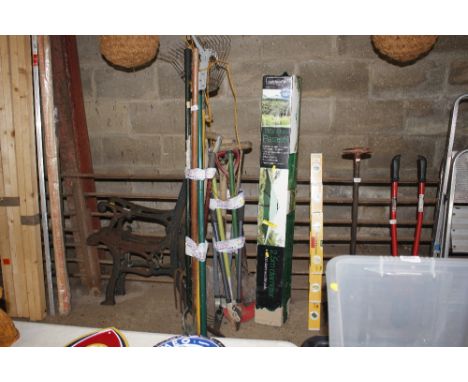 A wooden garden parasol; together with two bundles of long handled gardening tools