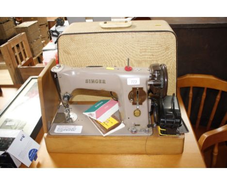 A Singer sewing machine in fitted case - sold as collector's item
