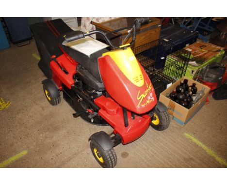 A Wolf Garten lawn mower/scooter with instruction manual