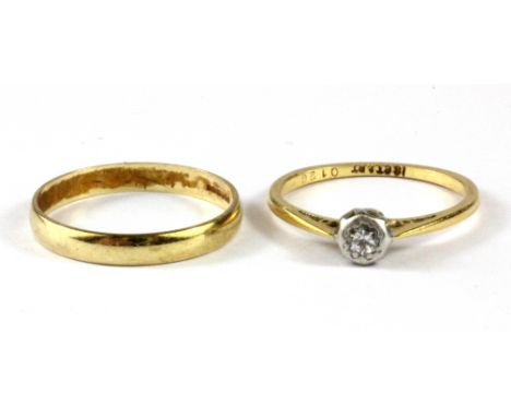 An 18ct yellow gold and platinum diamond set solitaire ring and a 9ct yellow gold wedding band.