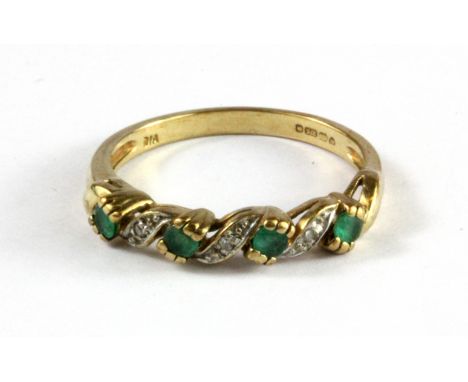 A 9ct yellow gold emerald and diamond set half eternity ring, (N.5).