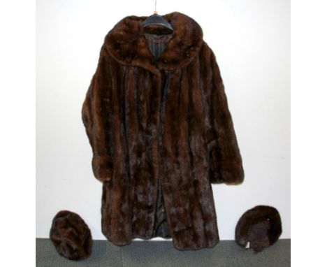A lady's vintage mink coat and two mink hats.