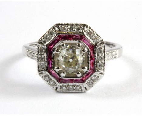 An 18ct white gold (stamped 18k) diamond and ruby set halo ring, set with a 0.88ct old cut centre diamond, (N).