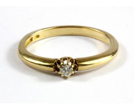 An 18ct yellow gold diamond set solitaire ring, (L).