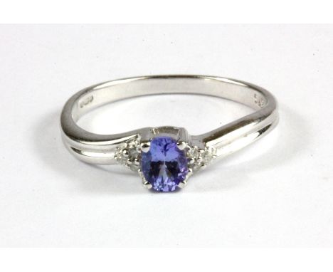 A 9ct white gold tanzanite and diamond set ring, (O.5).