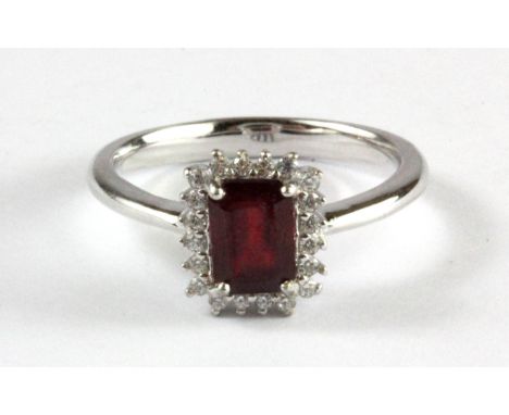 A 925 silver emerald cut ruby and white stone set ring, (O).