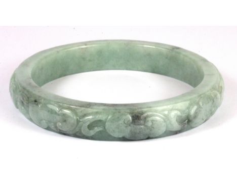 A carved jade bangle, Dia. 7.5cm.