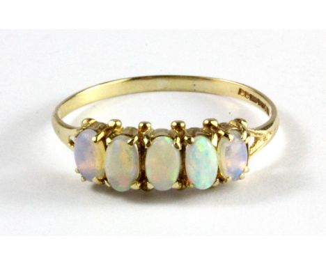 A 9ct yellow gold five cabochon cut opal set ring, (T.5).