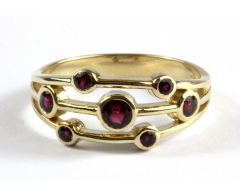 A 9ct yellow gold Boodles style ruby set ring, (Q).