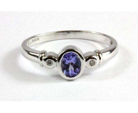 A 9ct white gold tanzanite and diamond set ring, (P.5)