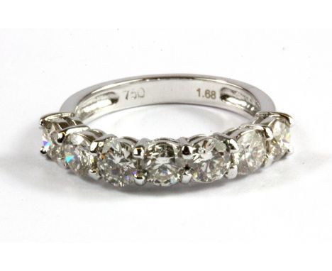 An 18ct white gold (stamped 750) seven brilliant cut diamond set ring, approx. 1.68ct, (N),