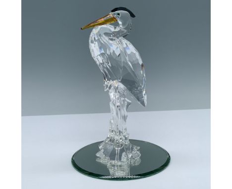 A clear crystal long legged bird with an amber beak and black feathers on the top of its head. Part of the Feathered Friends 