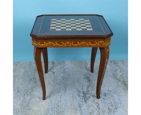 This fabulous wooden table features a lid with an exquisite inlaid floral pattern on one side and a chessboard design on the 