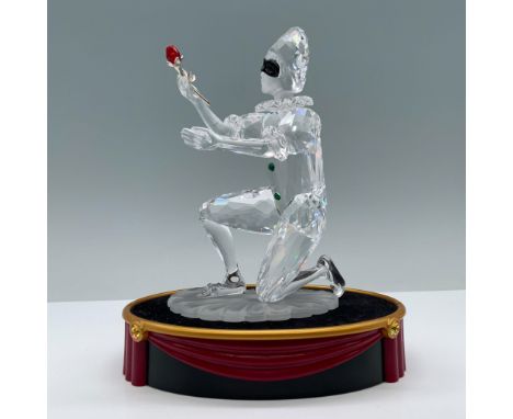 Clear, frosted, and color crystal of a masquerade harlequin holding a rose. Swarovski swan backstamp. 254044. This item has a