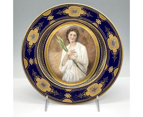 Cobalt blue enamel and raised gold gilt floral and geometric patterns surrounds central portrait of a young woman. Signed by 