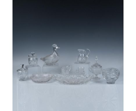 This dazzling collection includes one serving dish, two bowls, a tig, creamer, small carafe, and four lidded serveware pieces