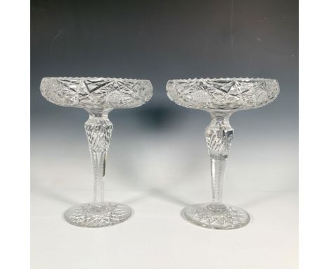 A stunning duo of decorative cut crystal serving bowls, set atop long footed stems, featuring an inverted scalloped rim, and 