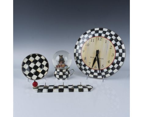 This whimsical four-piece collection features hand-painted metal bodies with an enamel checkerboard design, and includes a wa