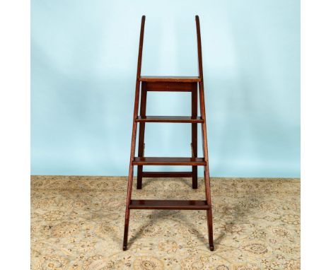 Stunning four-step ladder features rich, dark brown wood, brass-tipped treads, and gracefully scrolled stiles. Issued: 20th c