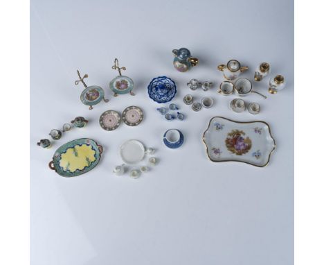 A carefully curated assortment of miniature porcelain tea sets and decorative pieces, beautifully crafted with intricate deta