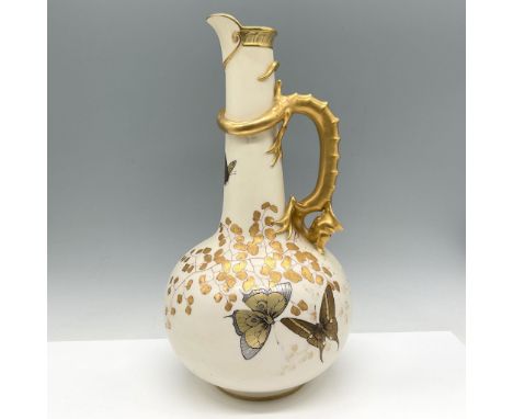 Elegantly crafted porcelain ewer features a bulbous body with a slender neck, adorned with gilt handle. Cream-colored porcela
