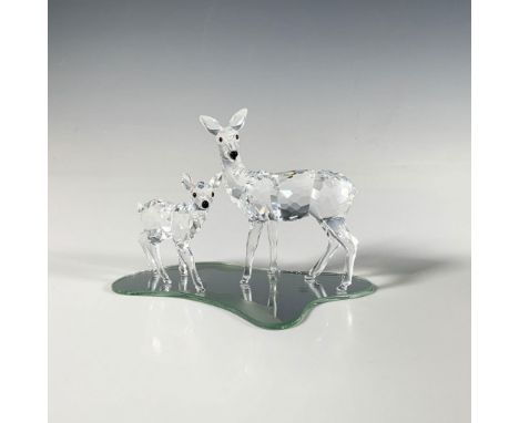 This lovely set of clear faceted crystal figures includes a doe and her fawn, both beautifully adorned with iridescent eyes a