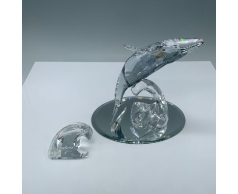 Spectacular 2012 annual edition clear cut crystal figure of a whale on its back on a wave. Includes crystal display sign. Pla