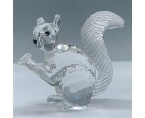 Clear crystal figural holding a nut, amber eyes, black nose and frosted, grooved tail. Swarovski swan backstamp. This item ha