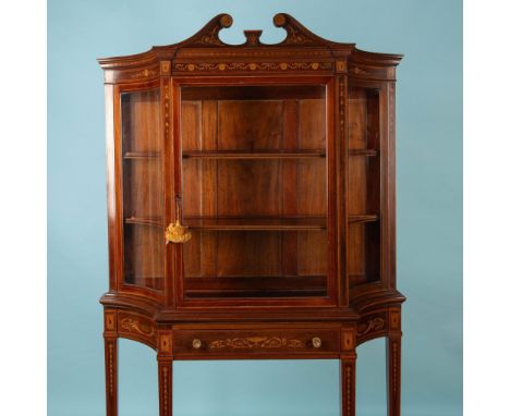 Ornately decorated cabinet with inlaid design on rim, legs and drawer. Cabinet has two wooden shelves with glass front and si