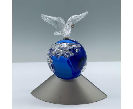 A breathtaking clear crystal dove atop a blue crystal globe, set on a sleek silver colored base. Swarovski swan backstamp. 23