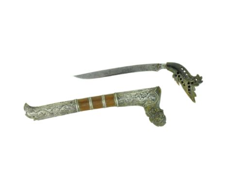 A late 19th Century Malayan Bade Bade knife / dagger. Pierced horn hilt in feather shape with a curved slender blade housed i