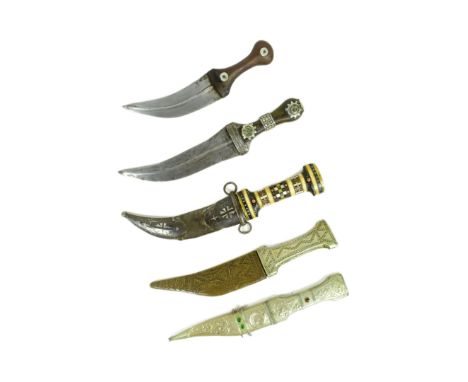 A collection of x5 vintage Middle Eastern / Arabian daggers to include a Shibriya with matching scabbard inset with red and g