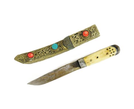 A 19th Century Tibetan / Bhutanese ladies belt knife. Bone handle secured to the tang with rivets, clipped single edged blade