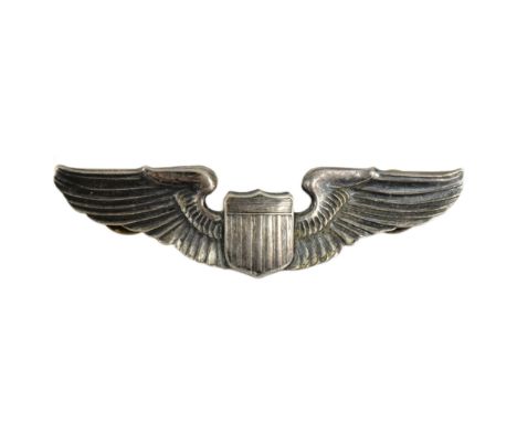 A WWII Second World War USAAF United States Army Air Force pilot wings badge. Stylized wings with a central shield. Stamped '