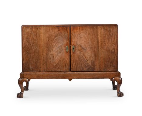 A GEORGE I WALNUT CABINET ON STAND CIRCA 1720 The doors opening to an adjustable shelved interior 91cm high, 135cm wide, 62cm