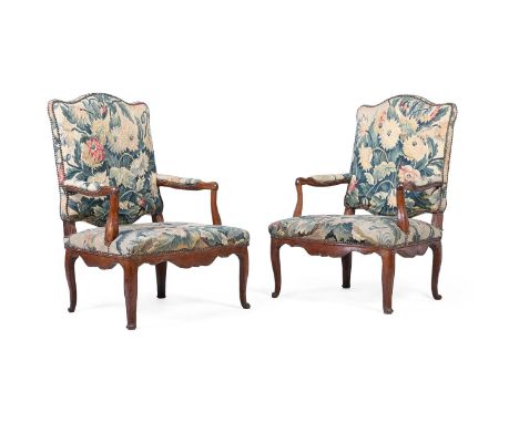 A PAIR OF EARLY LOUIS XV WALNUT AND TAPESTRY UPHOLSTERED FAUTEUILS  CIRCA 1730  each 101cm high, 73cm wide, 62cm deep overall