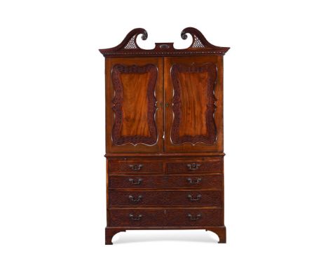 A GEORGE III MAHOGANY LINEN PRESS IN THE MANNER OF THOMAS BRADSHAW, CIRCA 1780 With fret work detailing, the doors opening to