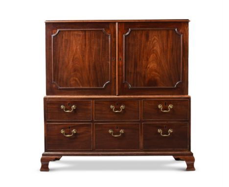 A GEORGE III MAHOGANY CLOTHES PRESS CIRCA 1780  Of unusual compact proportions, the doors opening to a sliding tray 126cm hig
