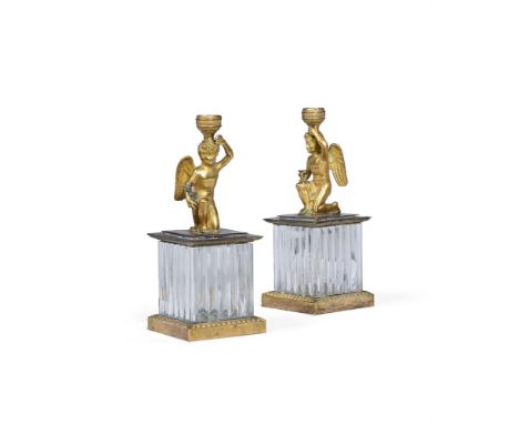 A PAIR OF EMPIRE STYLE GILT METAL AND MOULDED GLASS CANDLESTICKS  FRENCH, MID TO LATE 19TH CENTURY  Each modelled with kneeli