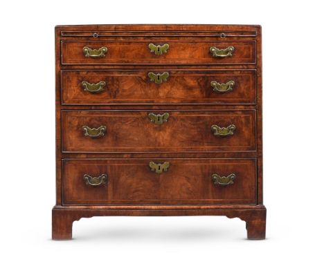 A GEORGE II WALNUT AND FEATHER BANDED BACHELOR'S CHEST OF DRAWERS MID 18TH CENTURY With a caddy top and brushing slide 78cm h